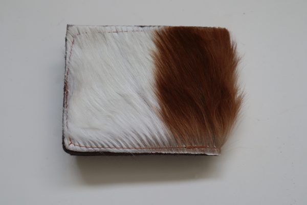 Springbok leather wallet with a distinctive natural pattern, featuring a rich blend of brown and cream colors, exuding rugged elegance and durability.